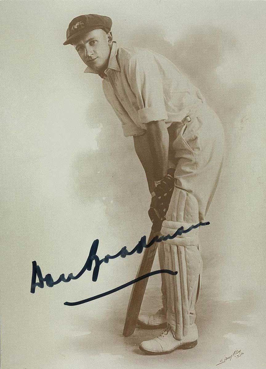 Autographed photo of Don Bradman posing with cricket bat in 1928. - click to view larger image