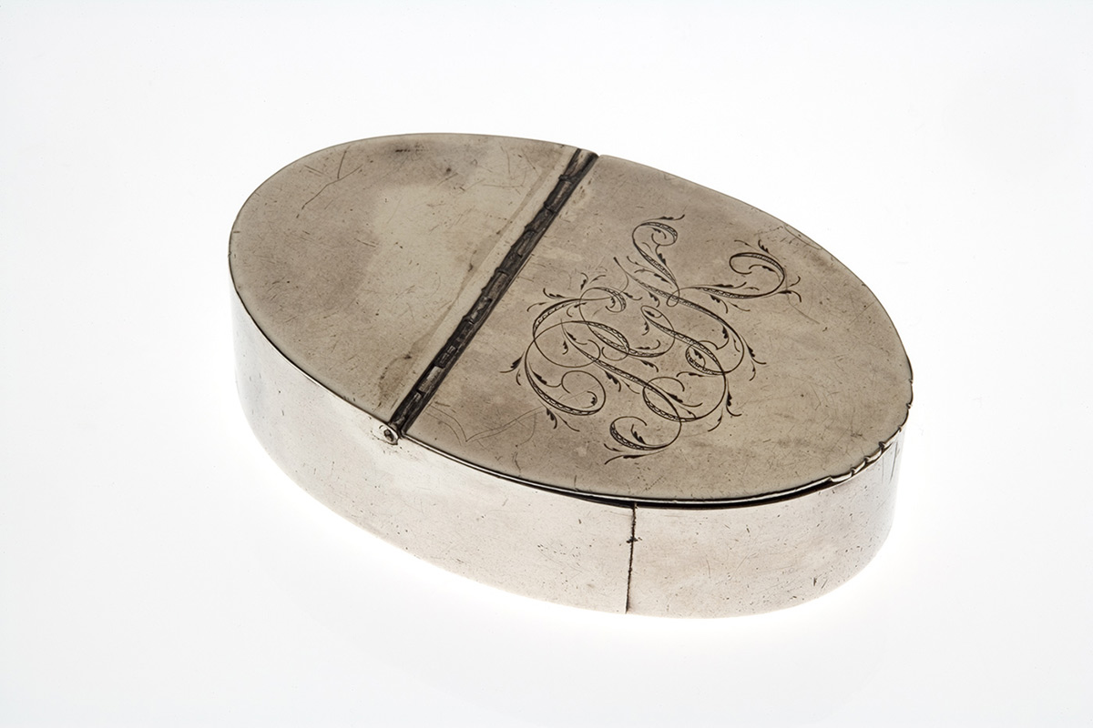 Oval-shaped silver snuffbox with intials PGK engraved on top. - click to view larger image