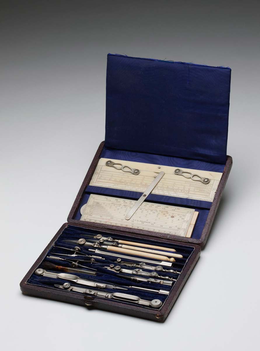 A case containing drawing instruments, opened to show the contents.