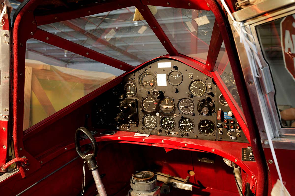 Photograph showing the interior of an aircraft cockpit. The instrument panel includes various gauges, button and switches. - click to view larger image