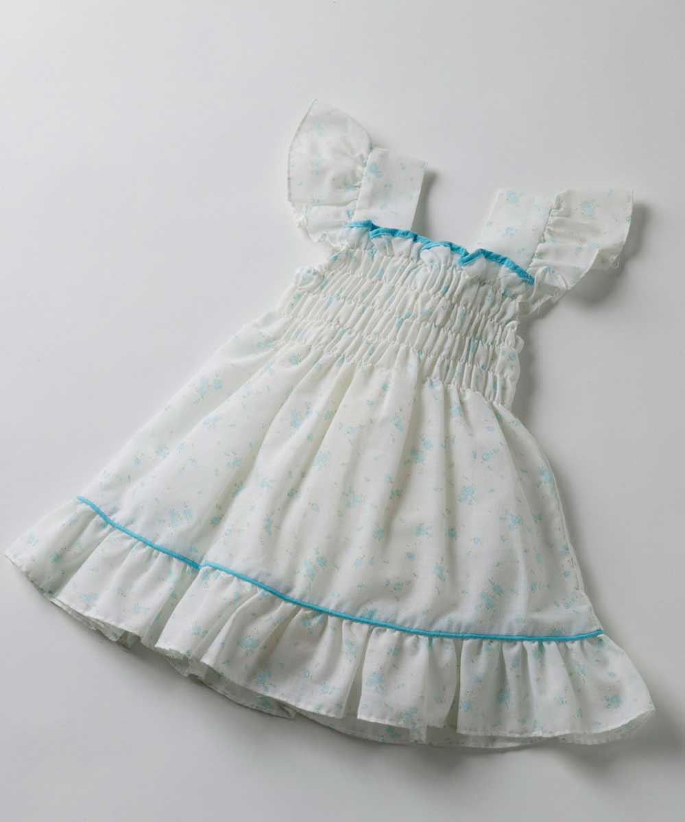 White child's dress with smocked front and aqua trim. - click to view larger image