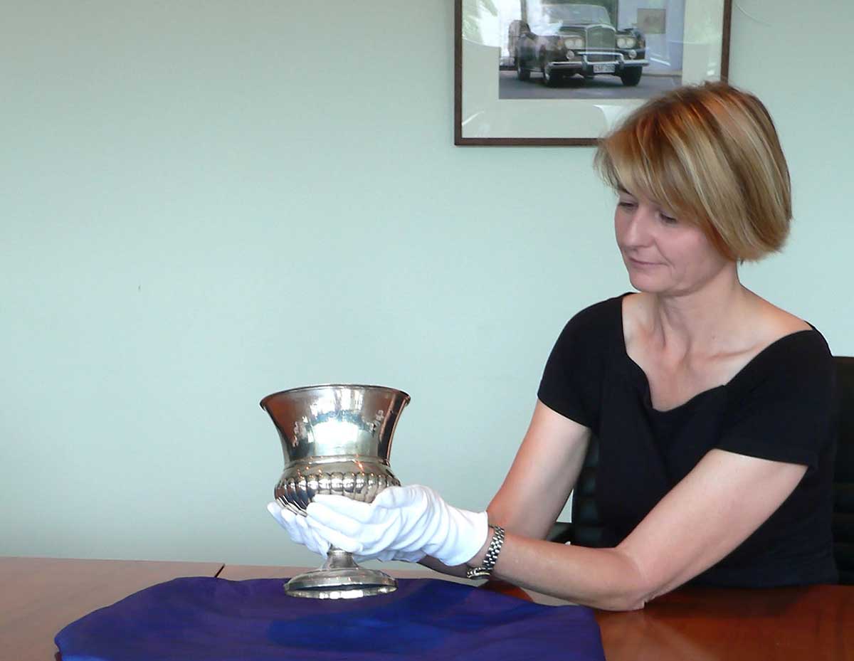 National Museum curator Kirsten Wehner holding the Junius Cup. - click to view larger image