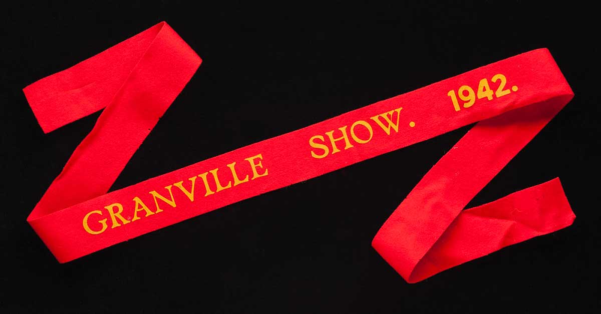 A red prize ribbon with yellow words: 'Granville Show, 1942.' - click to view larger image