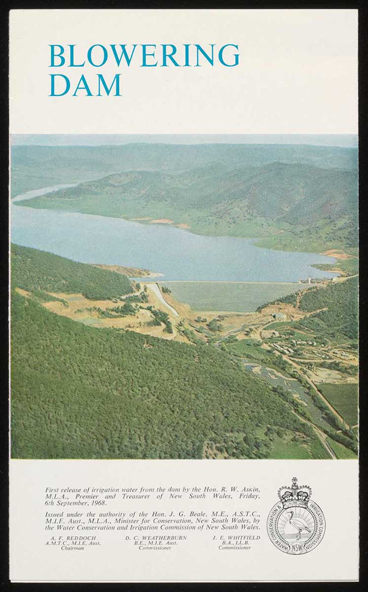 Cover of a booklet titled 'Blowering Dam' showing an aerial photo of a large dam and surrounding landscape. Text and a small crest also feature at the bottom. - click to view larger image