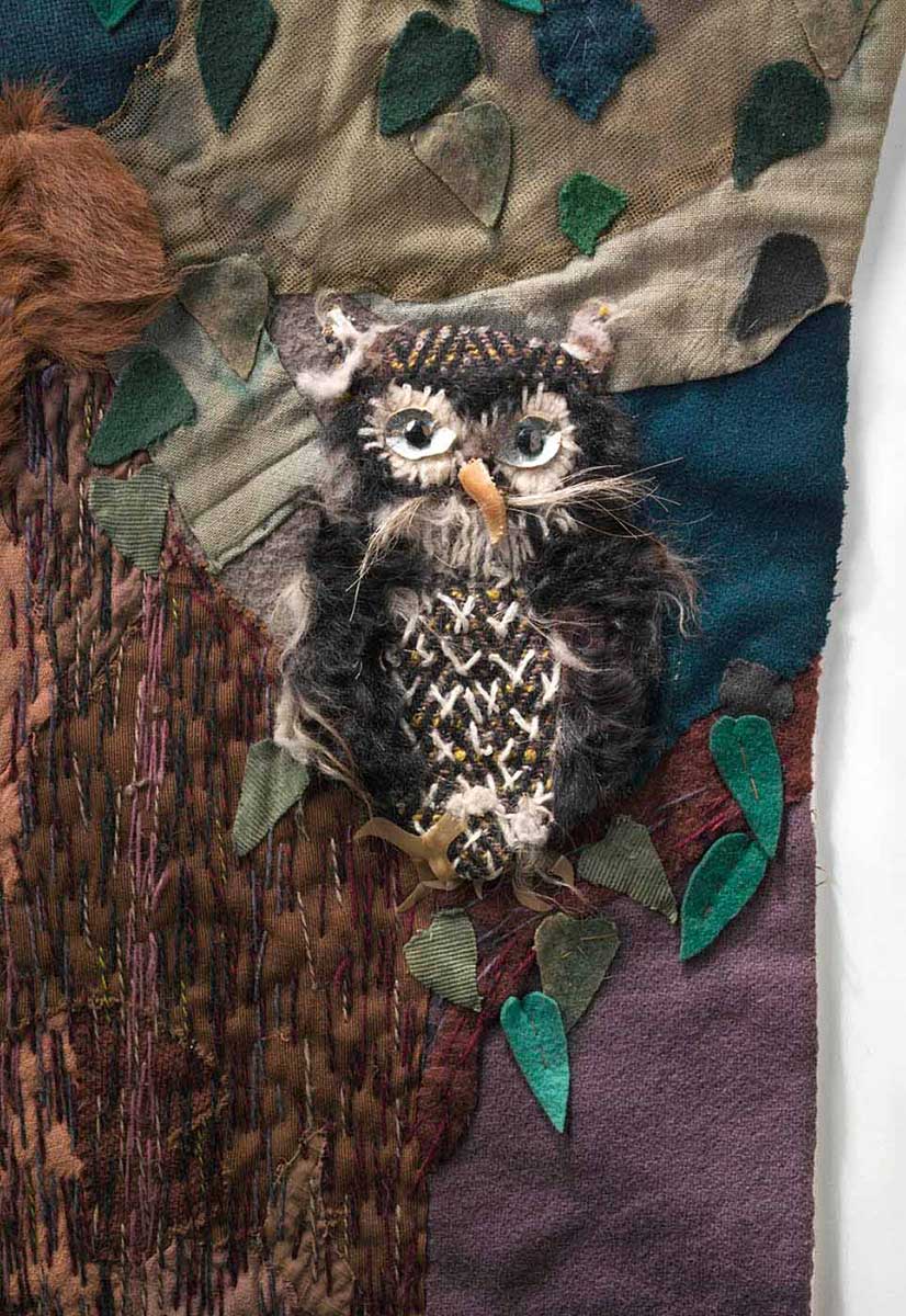 Detail from the Little Red Riding Hood wall-haning depicting an owl made fur and a variety of other fabrics including felt. - click to view larger image