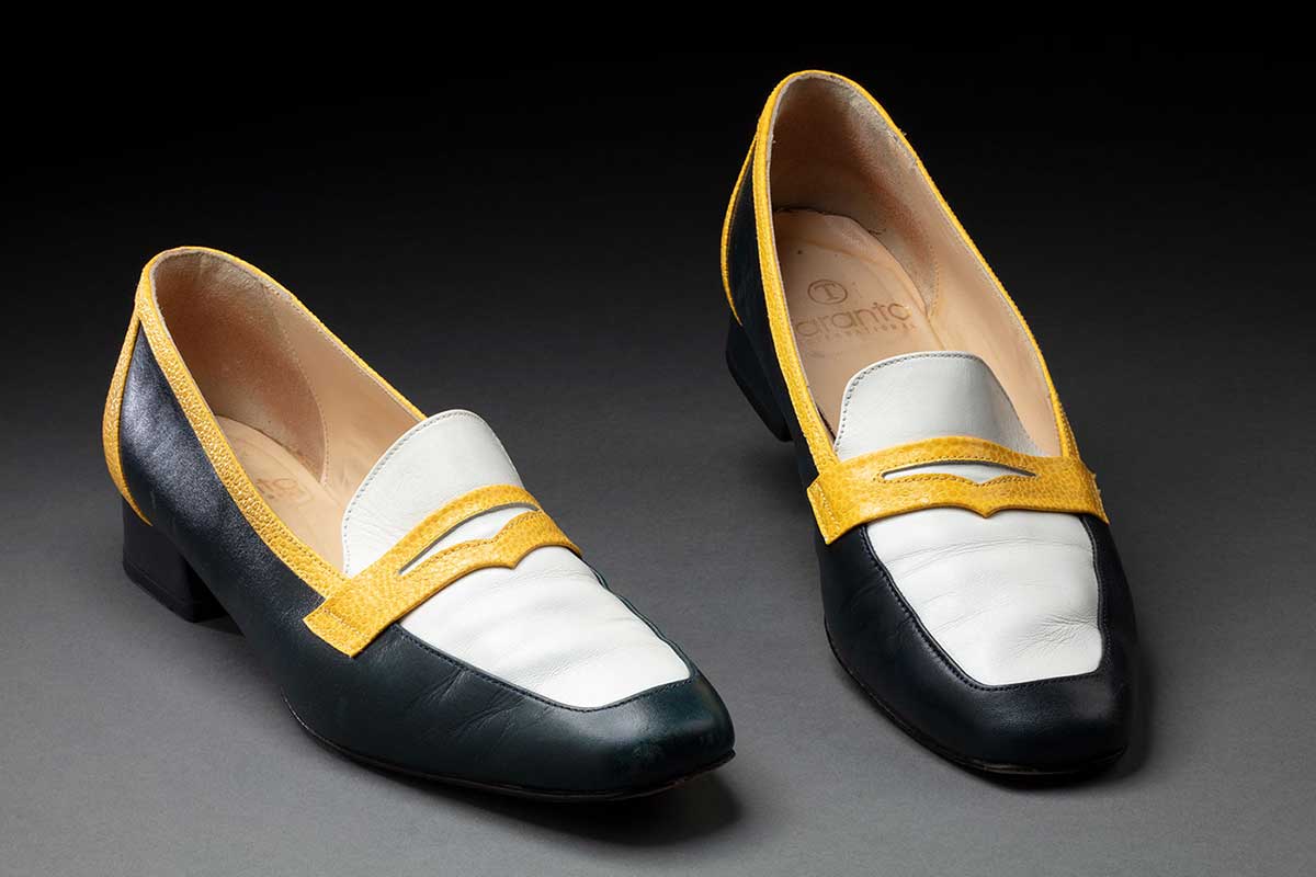 Pair of navy, yellow and white shoes belonging to Jackie Huggins.