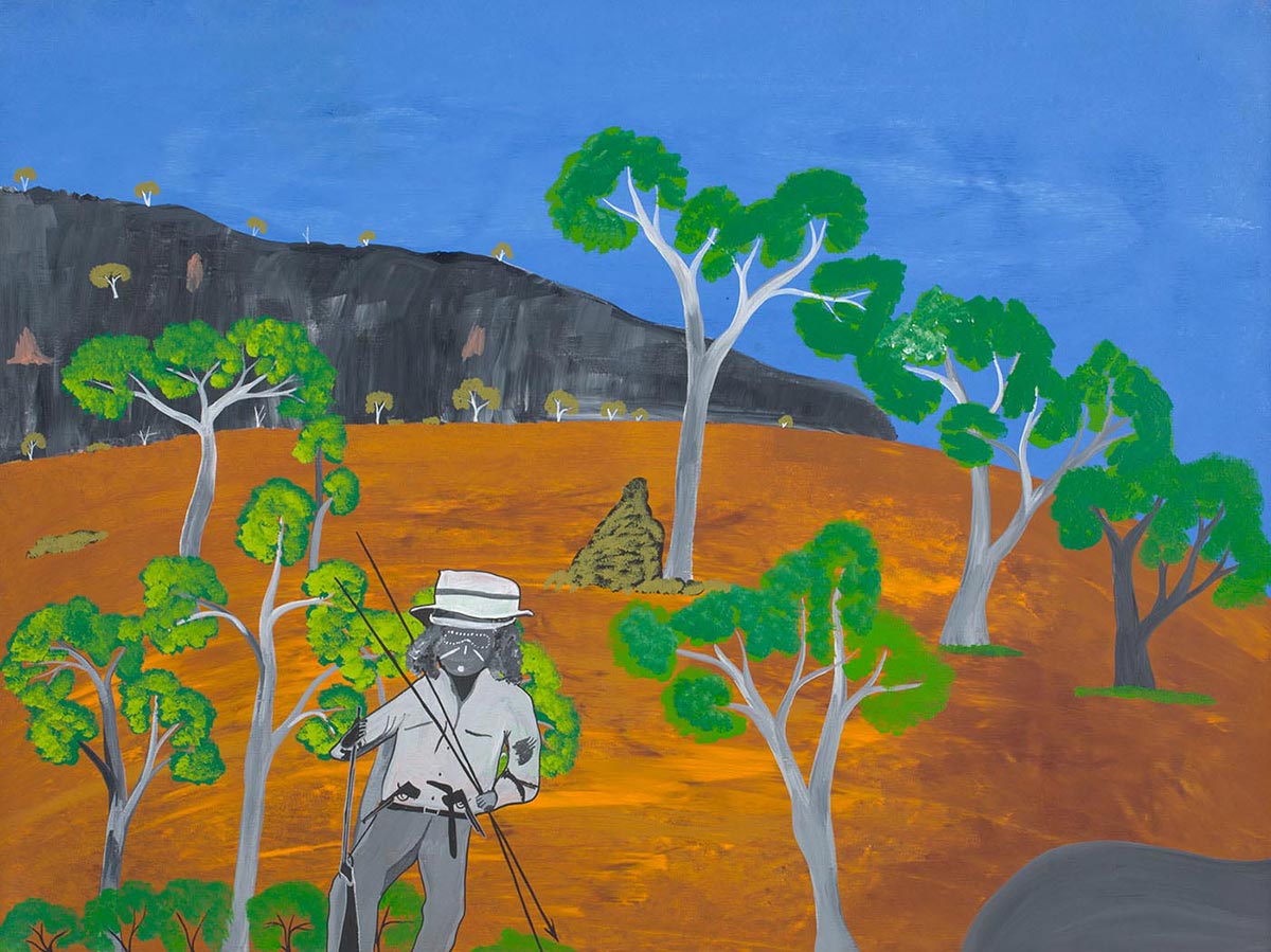 An acrylic painting on canvas depicting an Aboriginal man standing amidst a landscape. The man is wearing a white, grey and black brimmed hat, with a light grey shirt and dark grey pants. He is also holding spears in both hands. The landscape features a blue sky and grey black mountains with trees in the background. The foreground consists of orange brown grassland with trees that are green, grey and white in colour. Also to the front right side of the painting is a grey rock.