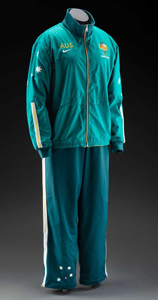 Dark green tracksuit top and pants, with gold trim, on a mannequin. - click to view larger image