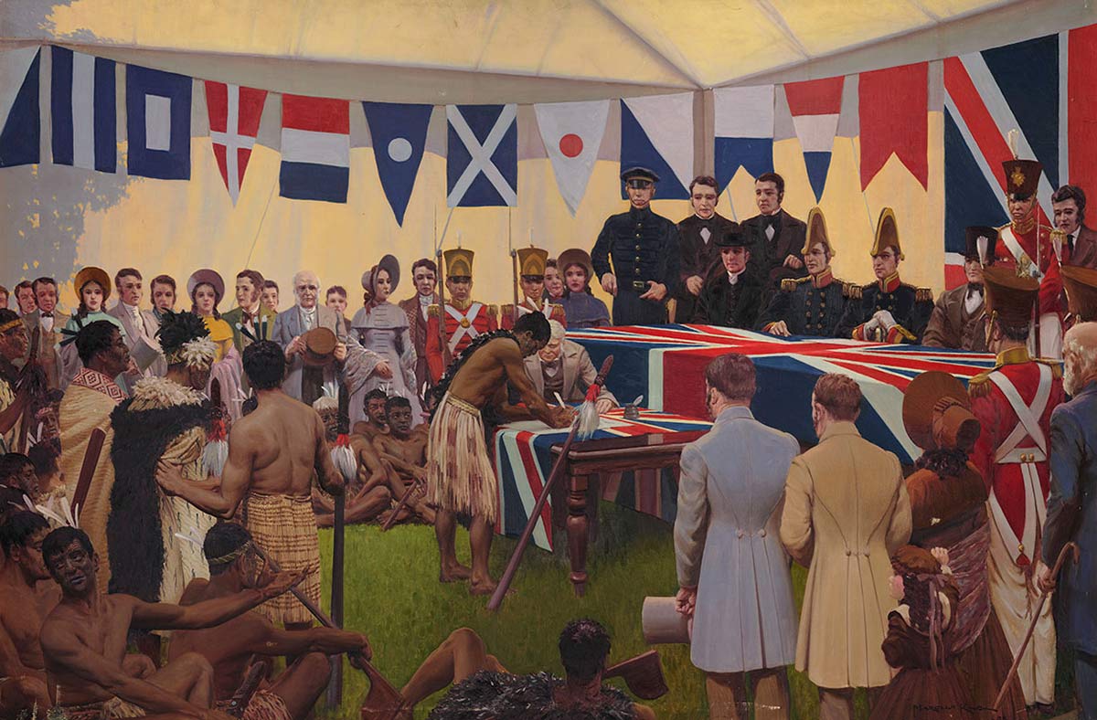 A Maori man signs a document on a flag-covered table, surrounded by Maori and European onlookers.