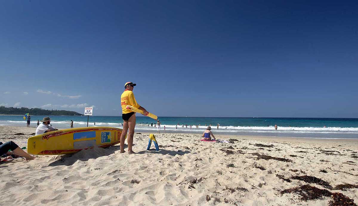 Surf lifesaver patrolling the beach at Mollymook, New South Wales, 2006.