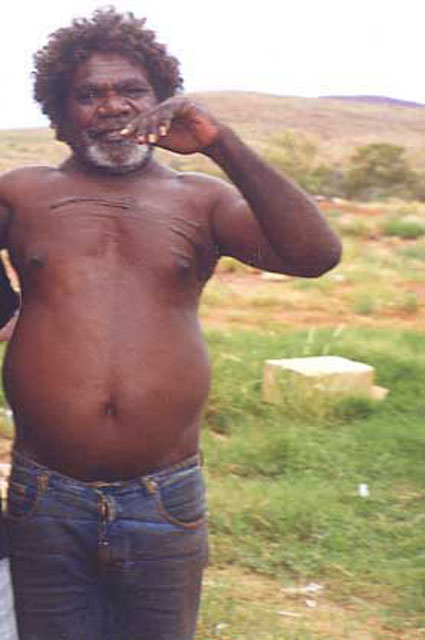 Portrait photo of an Aboriginal Australian man wearing blue jeans. - click to view larger image