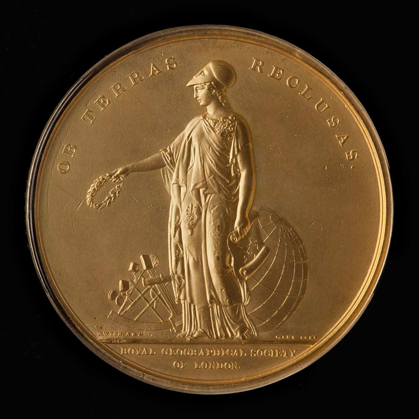 Coloured photograph of a circular, gold-coloured medal. - click to view larger image