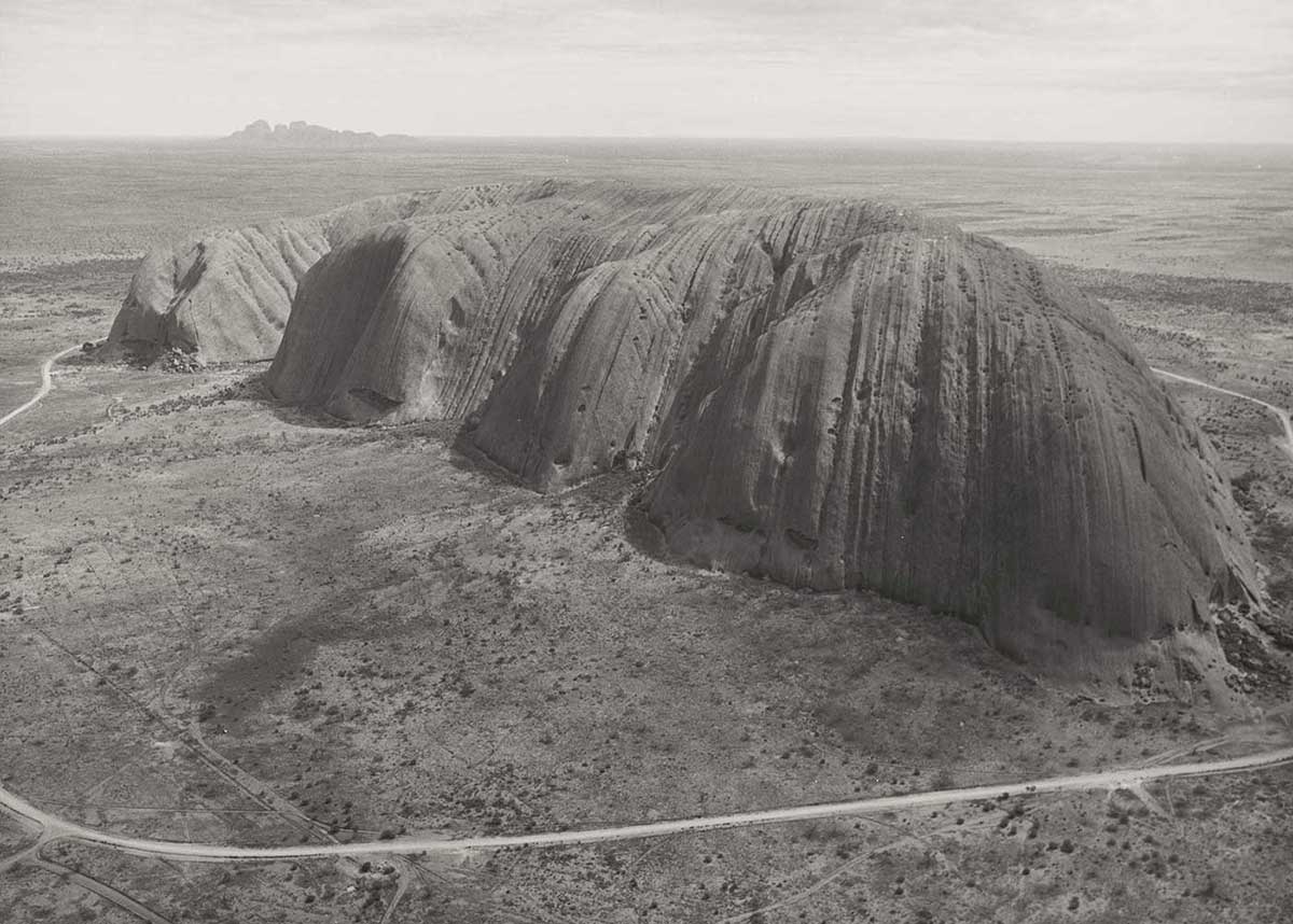 Black and white photo of Uluru and the surrounding National Park. - click to view larger image