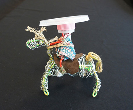 A small toy horse with rider.