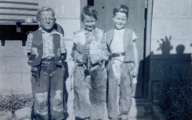 Black and white photograph of three young boys in costume. - click to view larger image