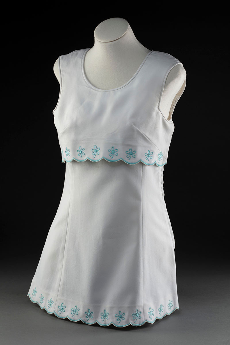 White tennis dress with pale blue trim, on a mannequin. - click to view larger image