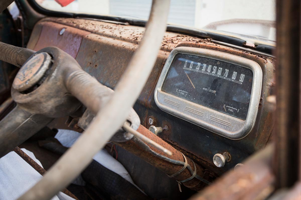 Detail of a dashboard with a compartment featuring a speedometer and fuel gauge. The odometer indicates 481,236. - click to view larger image