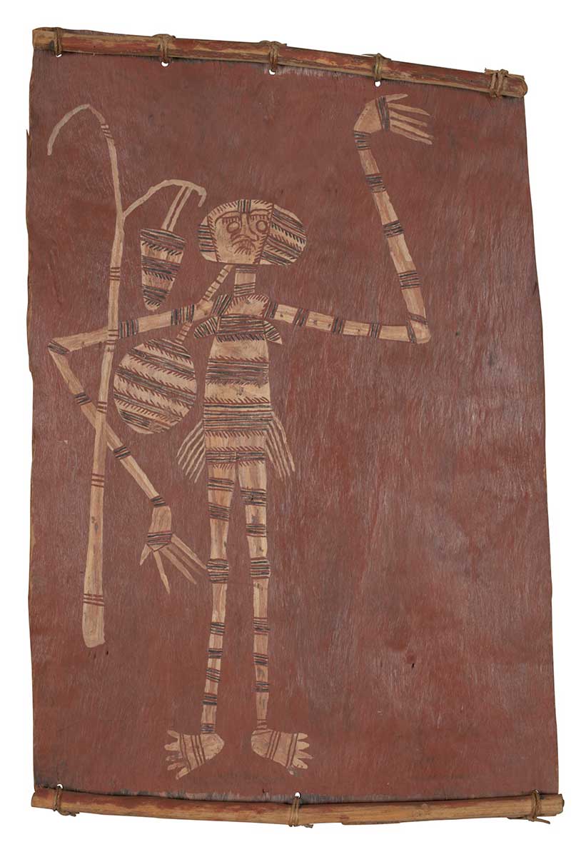 A bark painting worked with ochres on bark and on wooden restrainers. It depicts a female spirit with a fighting bag and a forked tree next to her with a hanging dillybag. These are painted in pipeclay with bands of infill. This consists of widely spaced sets of transverse red and black lines. - click to view larger image