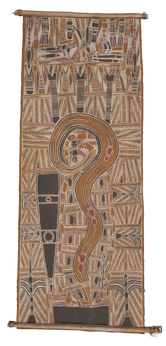 A bark painting worked with ochres on bark and on wooden restrainers. It depicts in the centre three figures surrounded by a large python with three other figures depicted inside the python. There is a black elongated shape on the left and a rectangular black shape at the foot of the painting. - click to view larger image