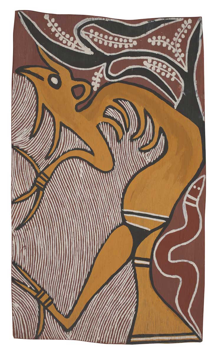 A bark painting worked with ochres on bark. It depicts a spirit painted in yellow with a red snake in the lower right hand corner and a black tree with white fruit or flowers in the upper right hand corner. The painting has a red background on the left and on the right a pattern of curved white lines on red. - click to view larger image