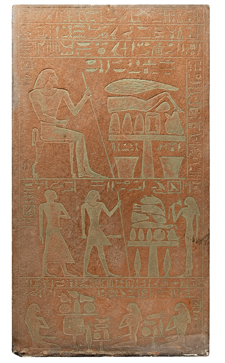 A reddish stone stela carved with hieroglyphs and figures.