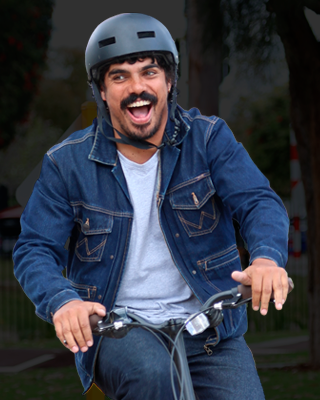 Tony Armstrong on a folding bike, with a suburban backdrop.
