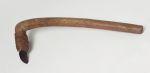 Small stone adzes with round handle and knee made of a light brown, lightweight wood with a four edged blade made of basalt, firmly attached to the shaft with plaited coconut fibres.