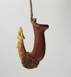 Two-part fishhook made of wood with twisted cord and lashing made of plant material.