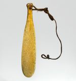 club made of whalebone, with hole drilled at the grip end, with strap made of plaited cord.