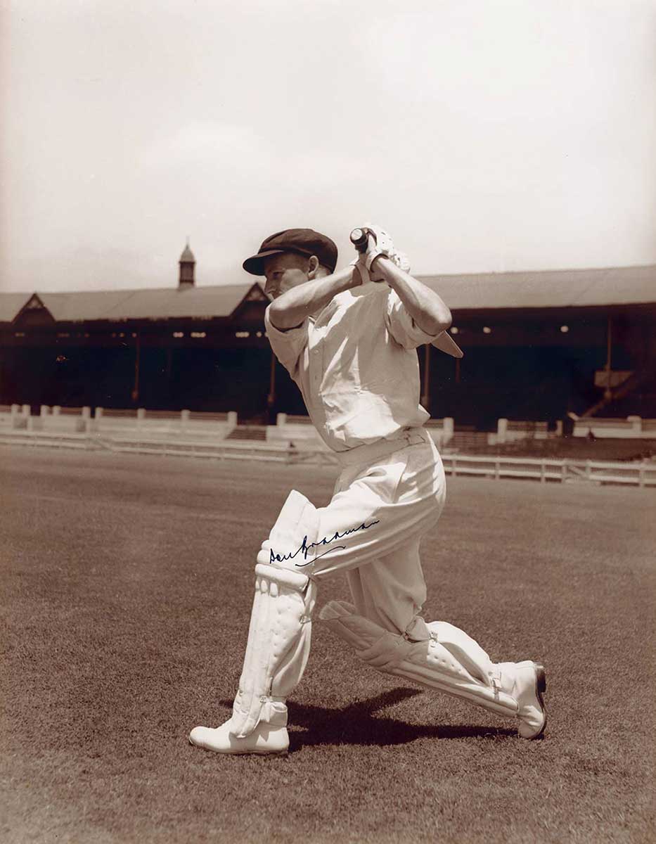 Batsman hitting ball, with stadium in background