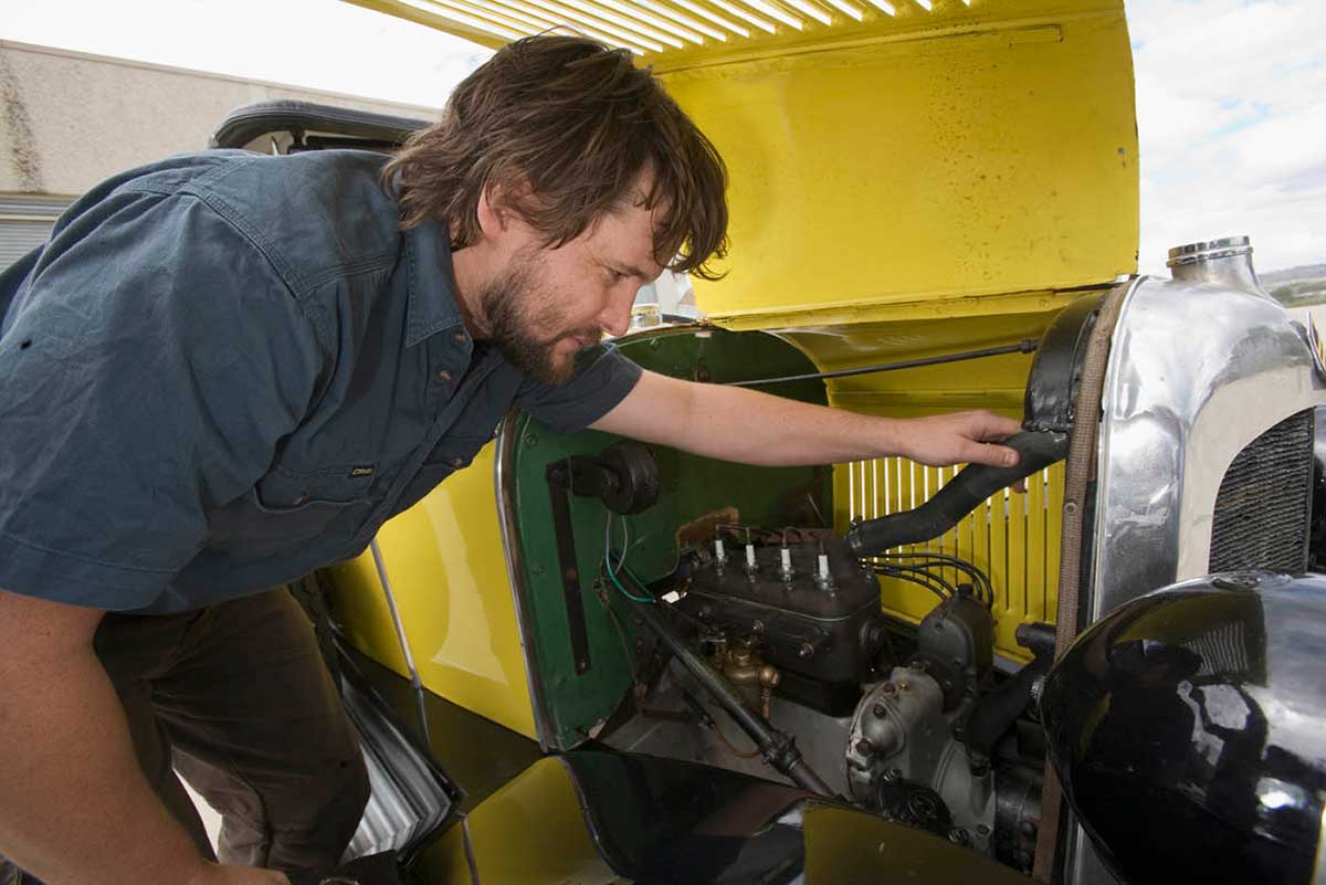 Conservator Ainslie Greiner looks under the Citroen's engine cover. - click to view larger image