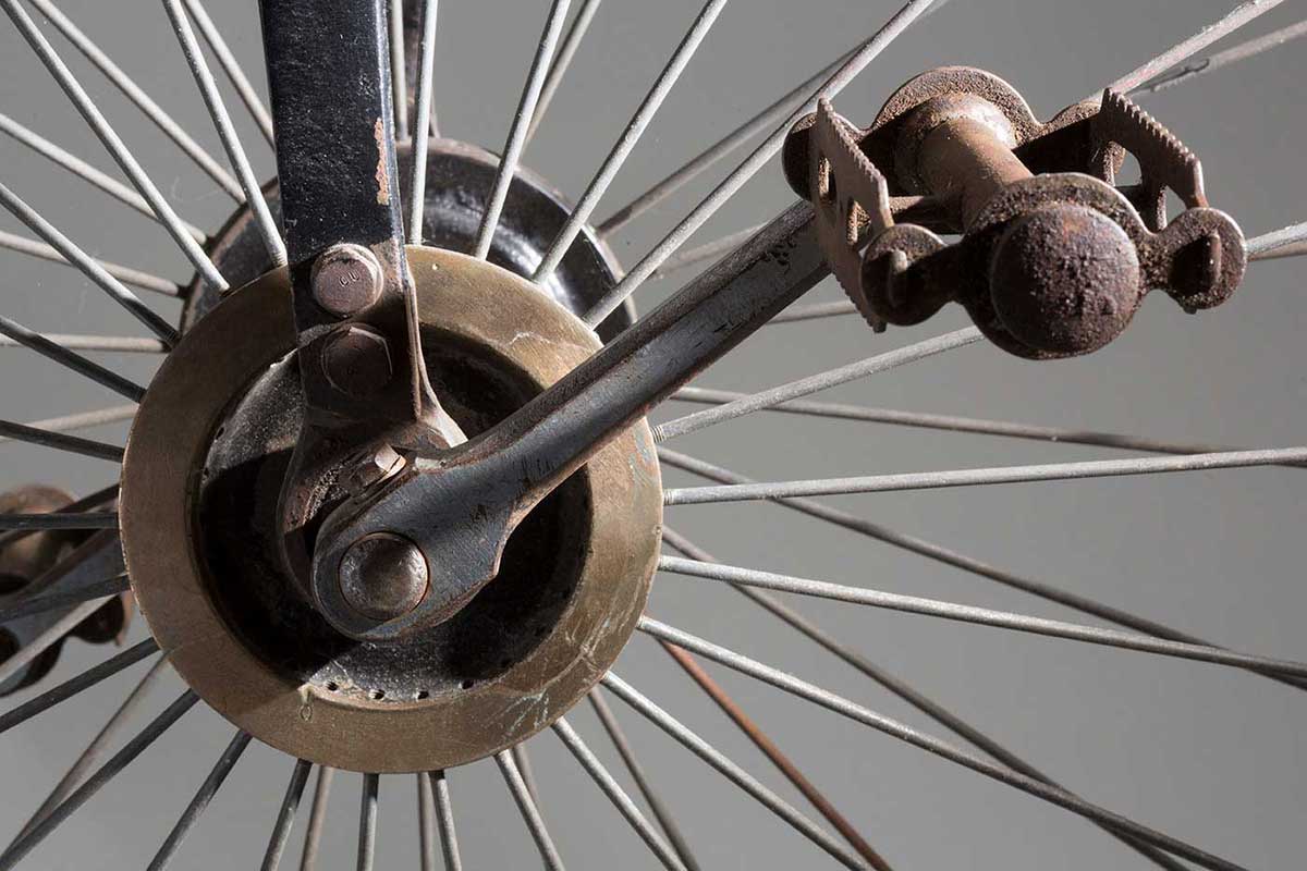 Close up image showing the side view of part of a bicycle wheel and pedal. - click to view larger image