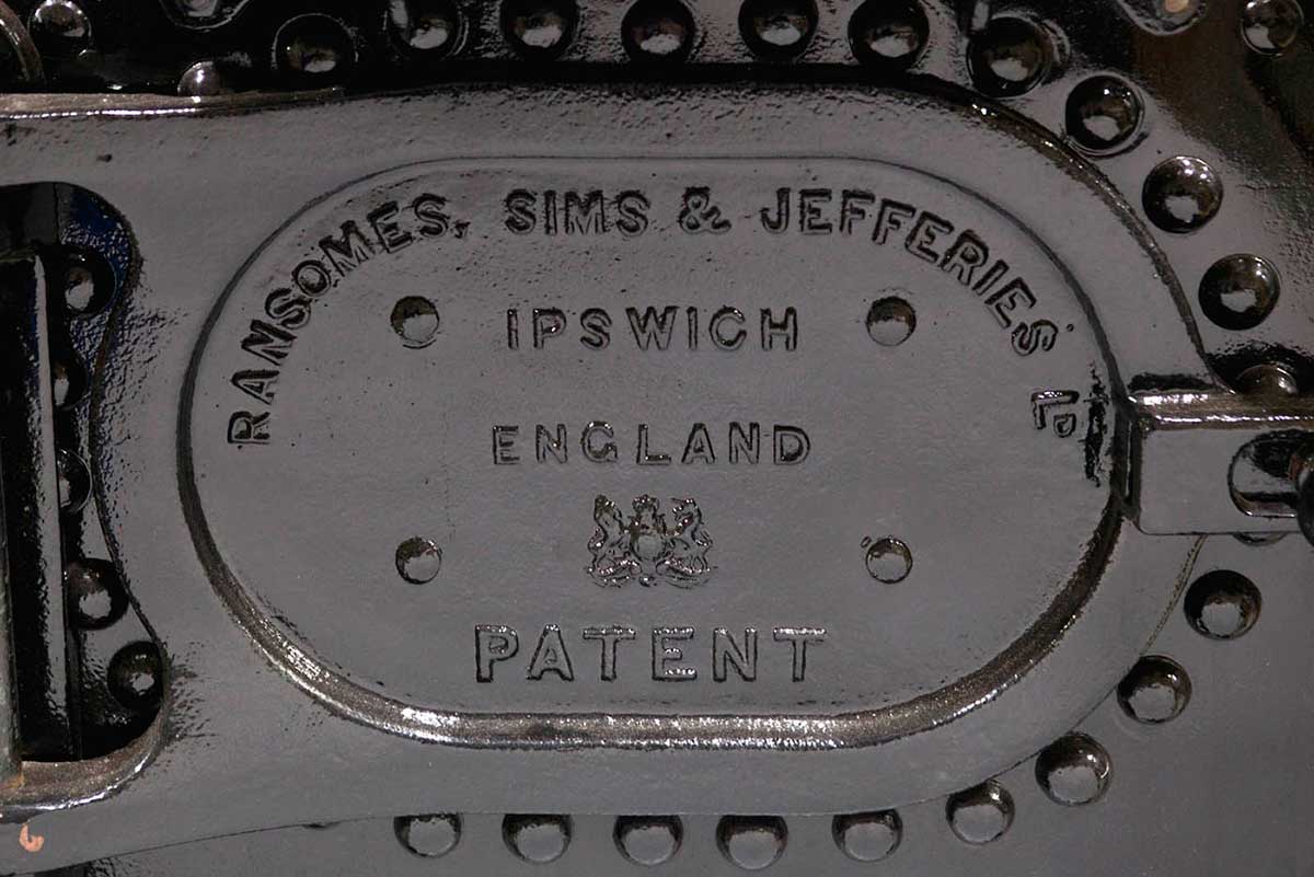 A close up of the text on the back of the steam engine's fire box which reads 'Ransomes, Sims & Jerreries, Ld, Ipswich, England, Patent.' - click to view larger image