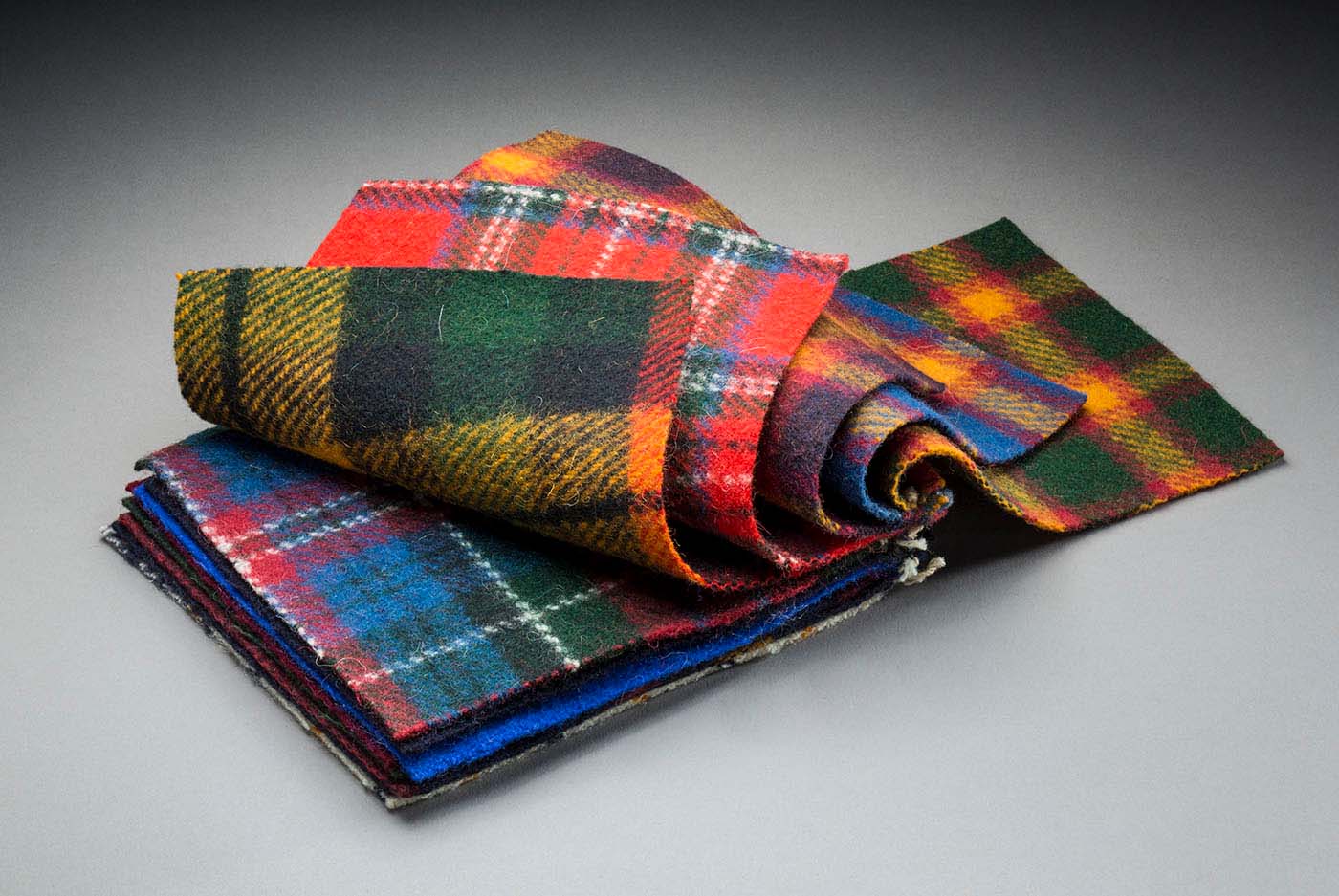 Bundle of saddlery cloth samples, stitched together into a sample book, before 1972 - click to view larger image