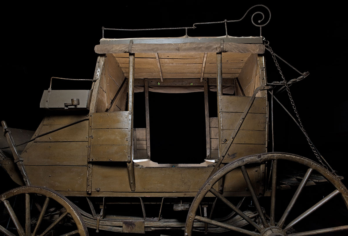 A horse-drawn, four-wheeled, eight-passenger ‘stage’ coach made from wood reinforced with iron strips and brackets - click to view larger image