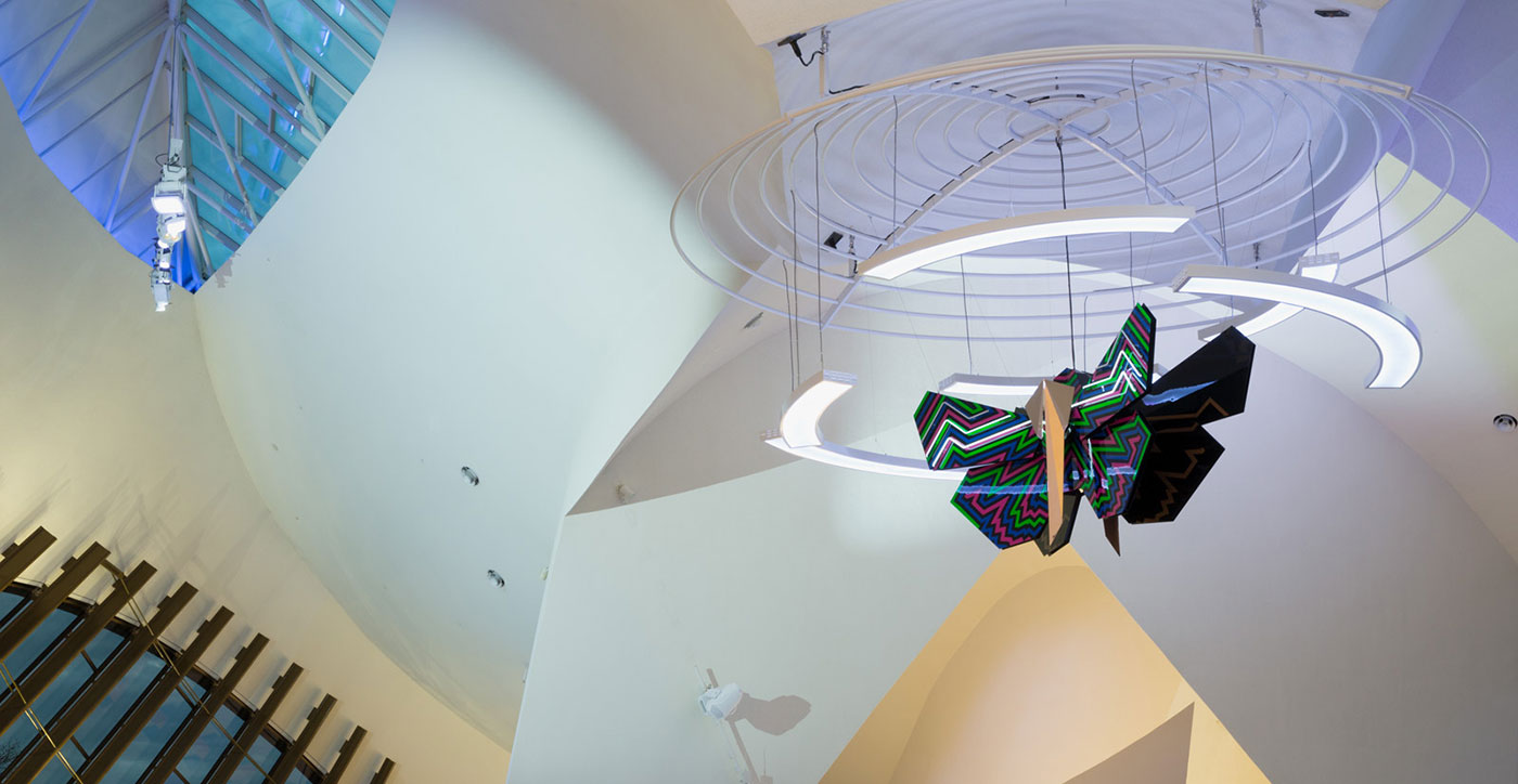 A reproduction of a Muttaburrasaurus, and Bogong Moth sculpture in the Gandel Atrium of the National Museum.ulpture