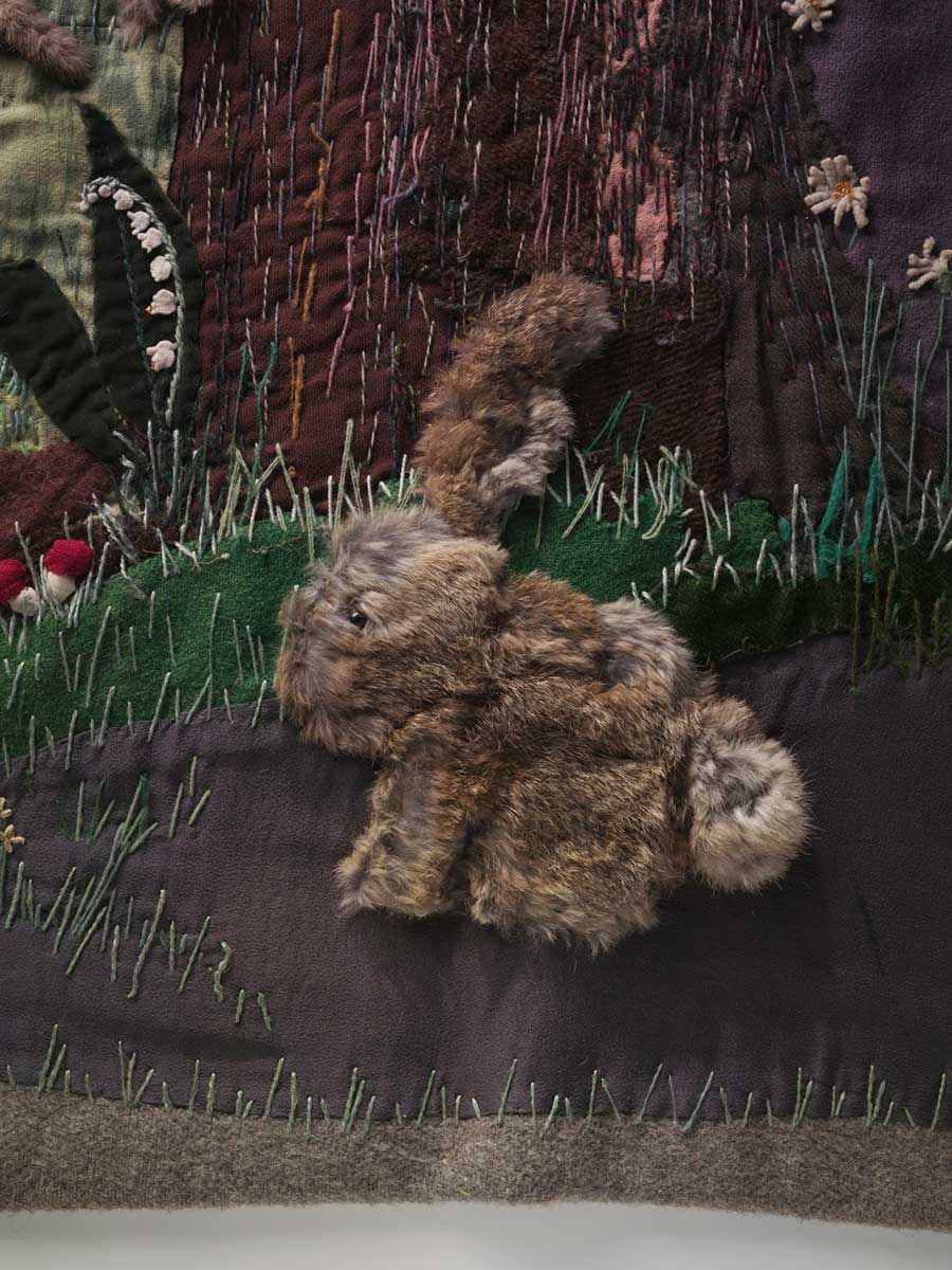 Detail from the Little Red Riding Hood wall-haning depicting a rabbit made fur and a variety of other fabrics including felt. - click to view larger image