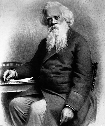 A black and white portrait of Sir Henry Parkes who is shown as seated at a desk.