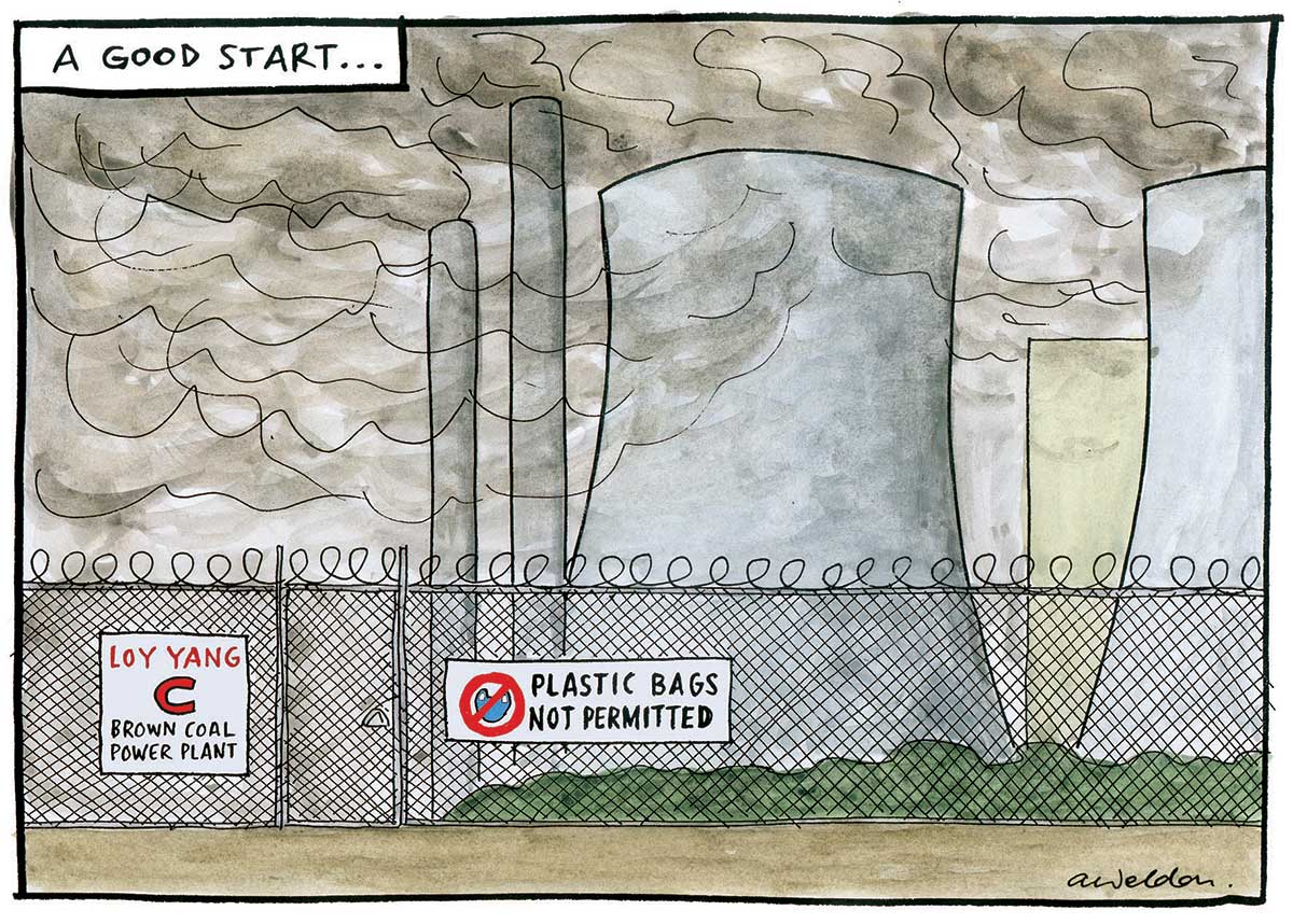 A power station behind a large chain link fence. The station's cooling towers and smokestacks are all emitting clouds of dark smoke. On the fence are two signs, either side of a gate to the left of the image. One says 'Loy Yang C Brown Coal Power Plant'. The other says 'Plastic Bags Not Permitted'. It also has a symbol of a plastic bag in a red circle with a diagonal red stripe over the bag. At the top left hand corner of the image in a white rectangle is written 'A good start'. - click to view larger image
