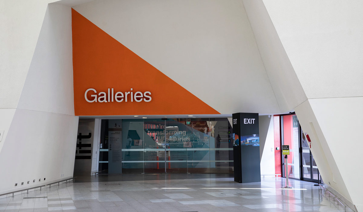 Glass sliding door entrance to a Galleries section.