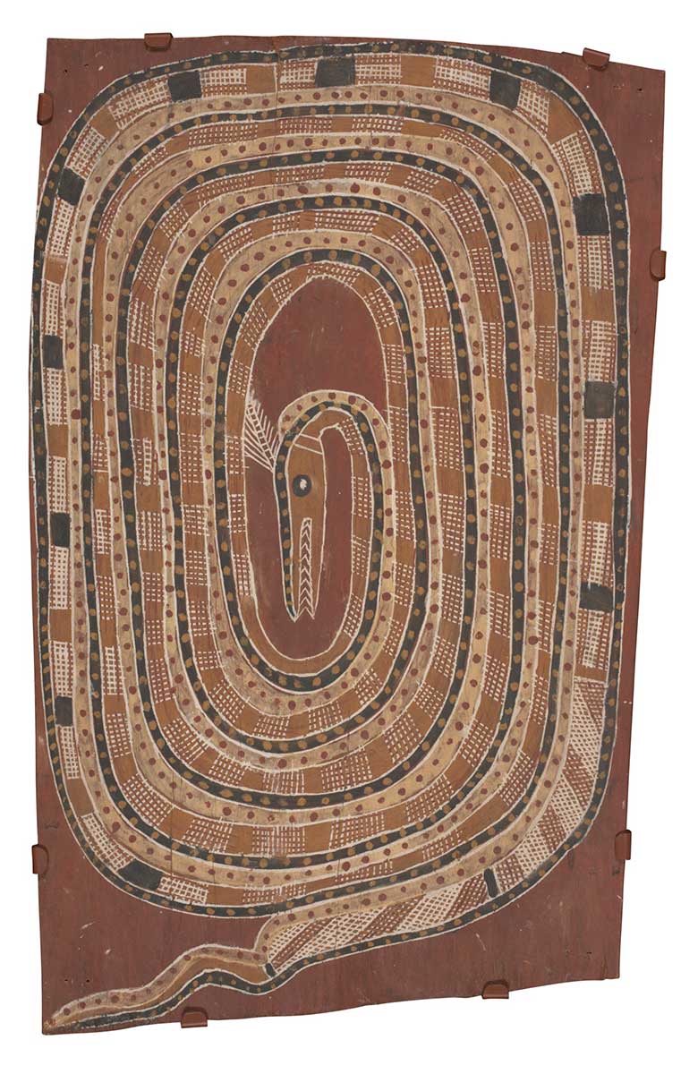 A bark painting worked with ochres on bark. It depicts a snake in a coiled position with its head in the centre. The snake is crosshatched in brown, cream, red and black rectangular shapes,which are outlined in black and white. The painting has a red background. - click to view larger image