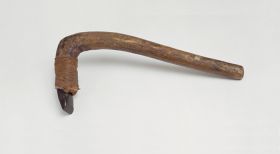 Stone adzes, with a round handle and knee made of a light brown lightweight wood with a four edged blade made of basalt, and attached to shaft with plaited coconut fibres.