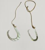 Fishhook made of mother-of-pearl, where strings made of various plant fibres are attached.