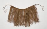 Skirt or apron made from fine shred of plantain leaf, dyed and knotted to a string that fastens around the waist.