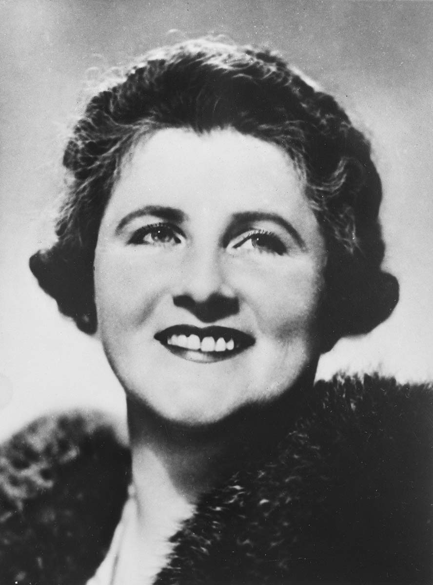 Black and white photo of smiling Dame Enid. - click to view larger image