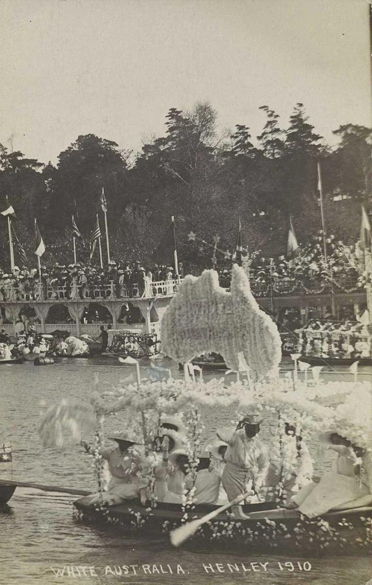 A boat with some kind of white structure supporting a white map of Australia. Six or seven people are on board dressed in white - click to view larger image