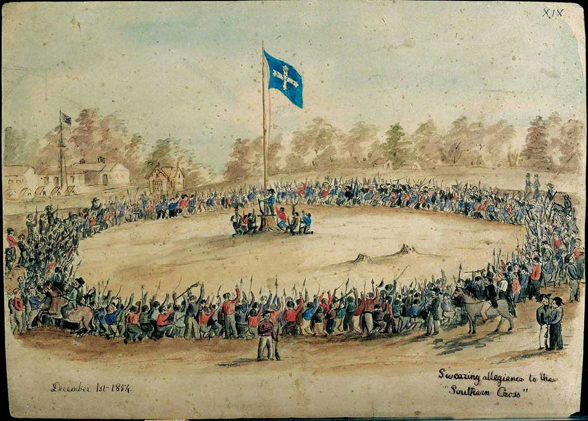 Hundreds of men encircle flag pole with Eureka flag at the top.