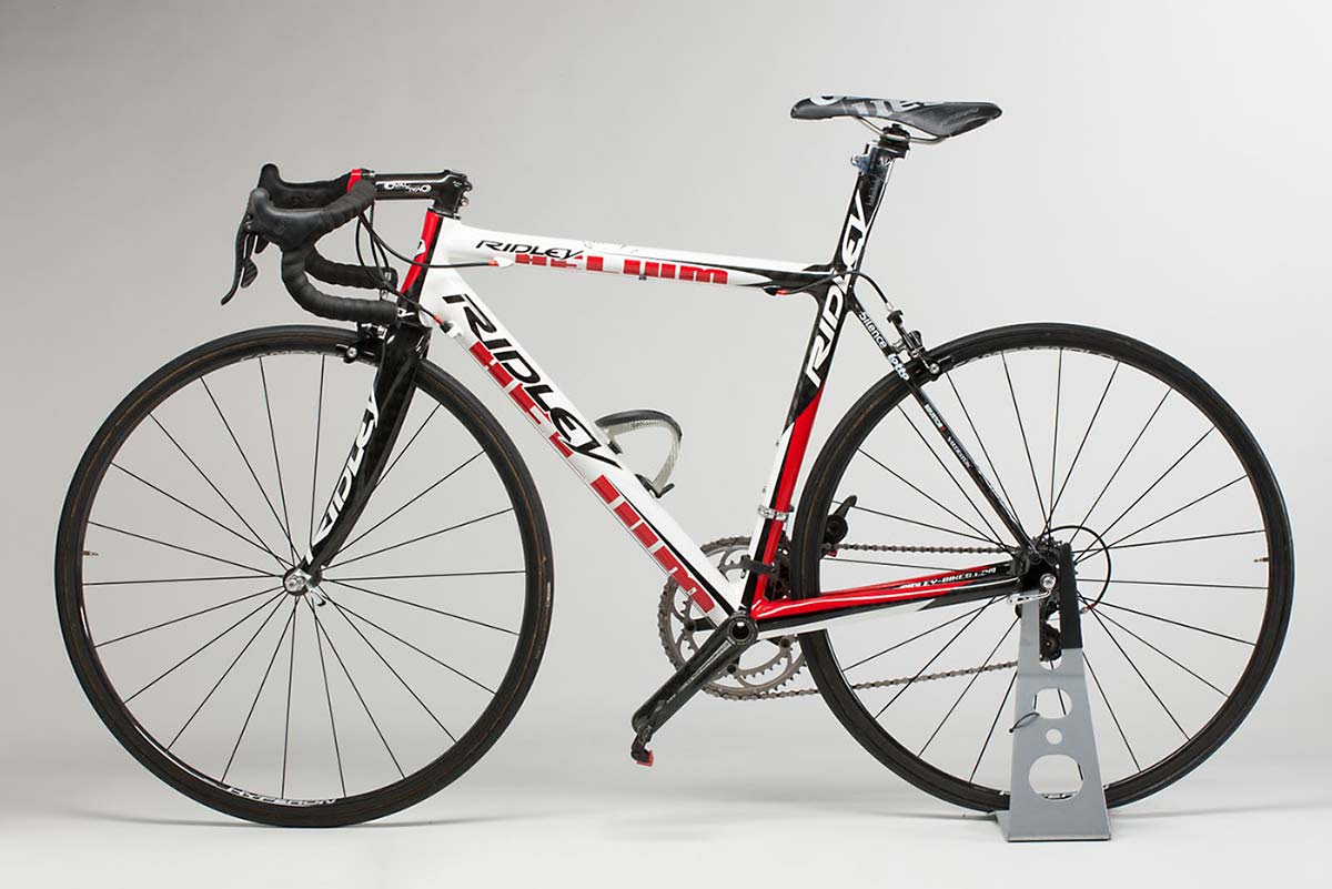 Side view of a Ridley 'Helium' racing bike, with black, red and white livery.