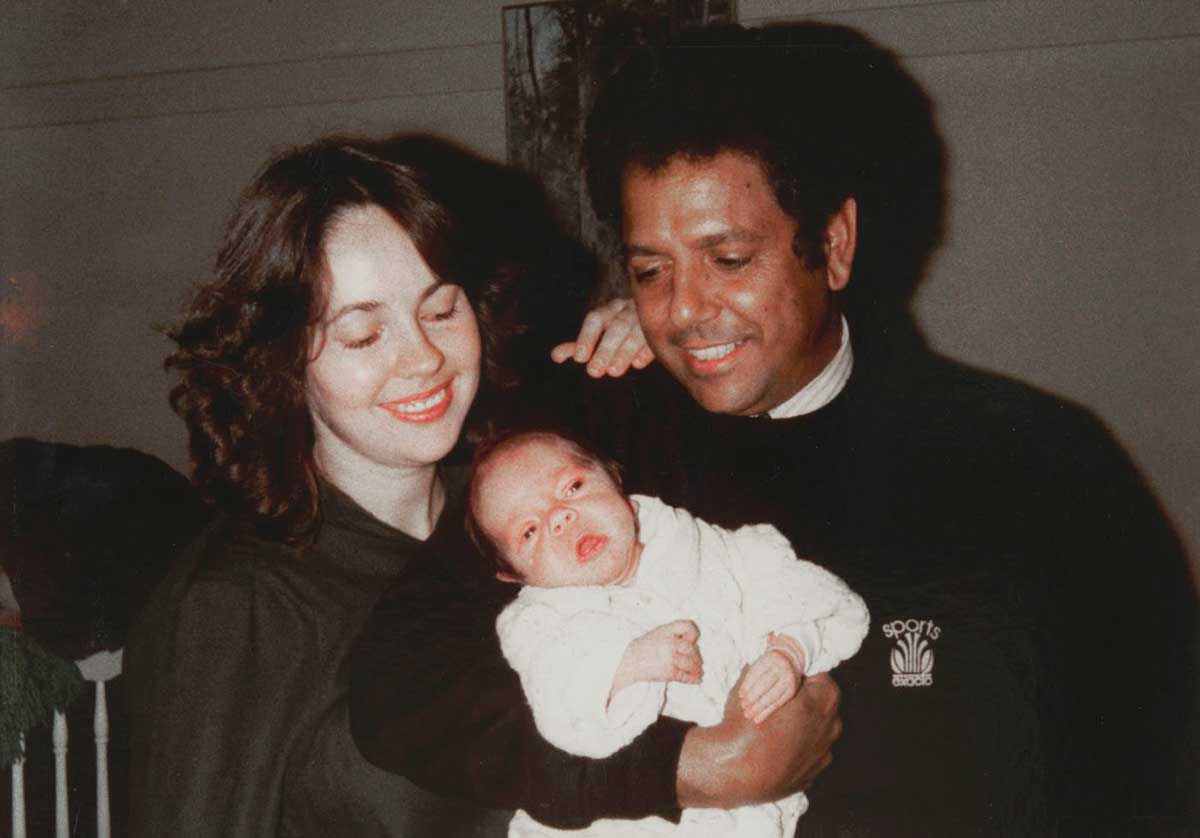 Colour photograph of a man, woman and baby. - click to view larger image