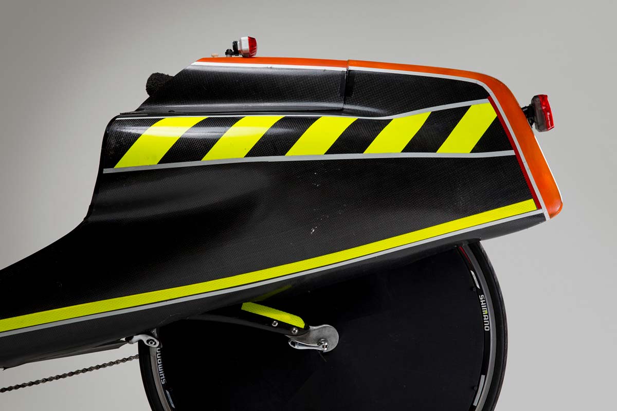 Close up colour photograph showing the side view of the tail box on a recumbent bike. Yellow and black Neon strips have been added for visibility. - click to view larger image